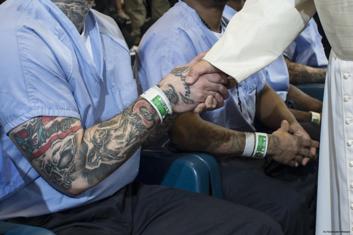 Pope Francis shakes hands with an inmate bearing a tattoo at the Curran-Fromhold Correctional Facility in Philadelphia Sept. 27, 2015. “He always tries to visit places where people are suffering,” Andrea Tornielli, editorial director of the Vatican Dicastery for Communication, told CNS.